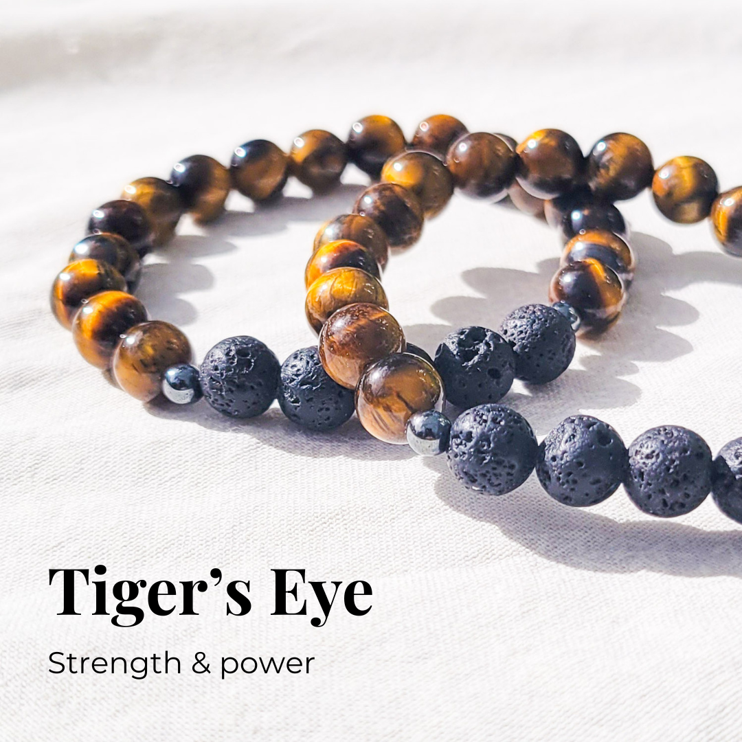 Tiger's eye diffuser bracelet with black lava stones and silver hematite spacers for essential oil diffusion.