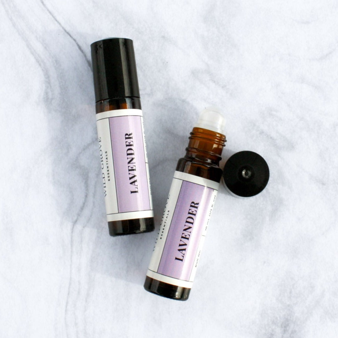 Essential oil roll-on bottle in 10ml amber bottle on a marble backdrop in Lavender scent.