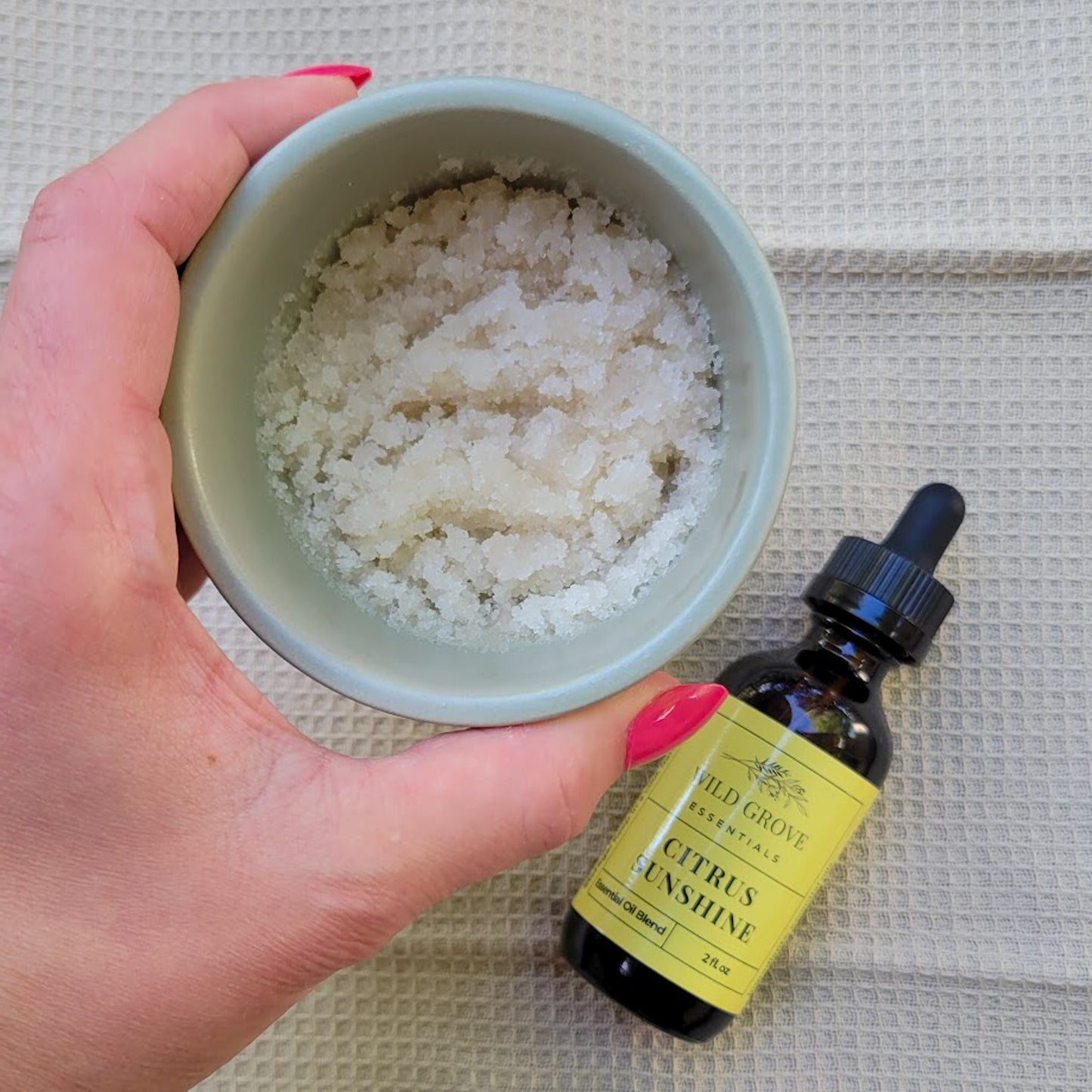 A small pot of sugar scrub made with Citrus Sunshine scented essential oil.